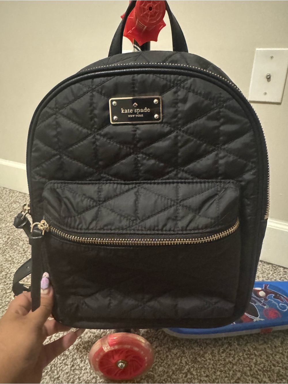kate spade Black Quilted Mini Backpack with Gold-Tone Plaque